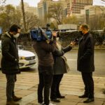 A Journalist Interviewing a Man in a City